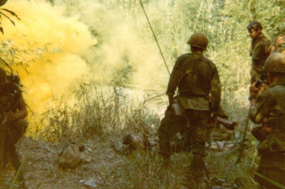 Medic walking toward female POW. Song-Be Vietnam 1970